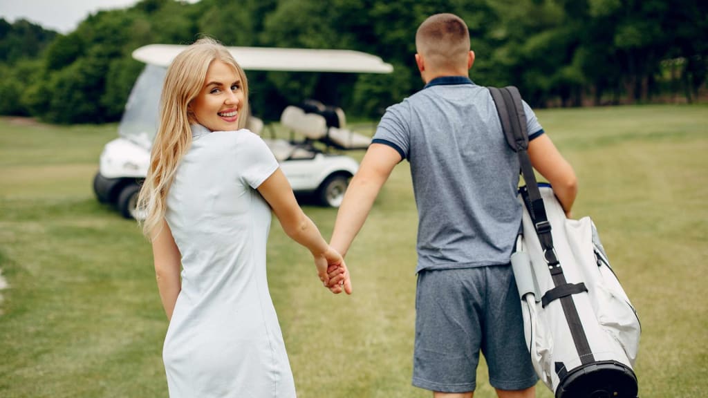 Beautiful Couple Playing Golf on a Golf Course
